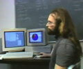 long haired programmer in front of classic macs those were the days