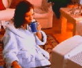 lady drinking morning coffee in front of PowerBook Duo