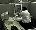 Man striking at monitor with keyboard
