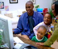 happy black family in front of iMac G5