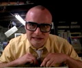 MC Frontalot in front of lots of retro computing gear
